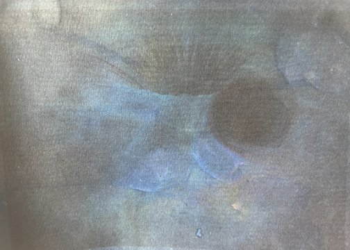ethereal tones of blue and grey surrounding a darker circle