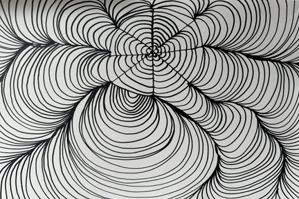 circles outlined in black on a pale grey background expanding outwards